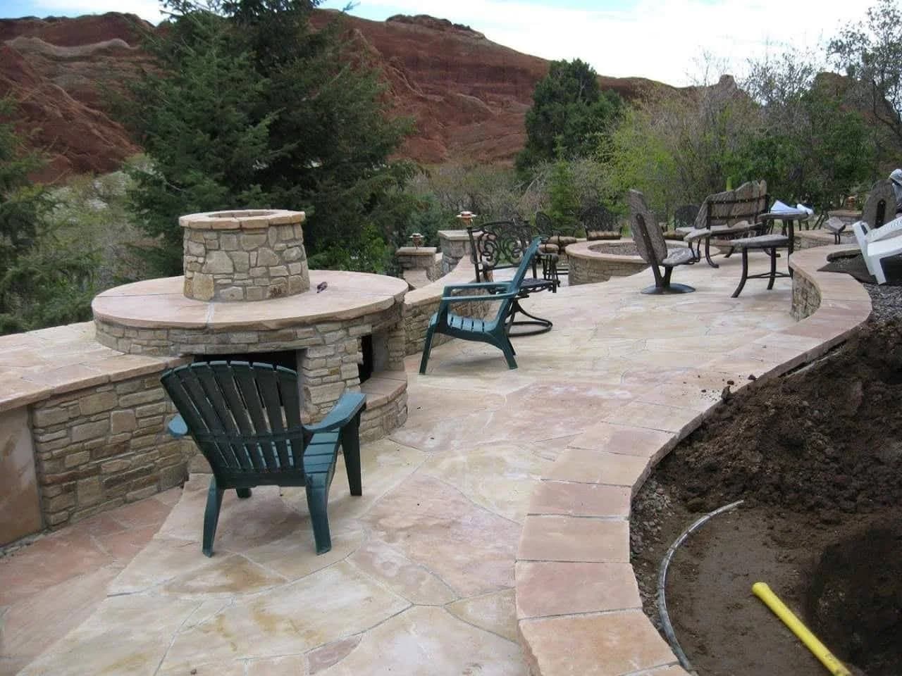 Fire pit with stamped concrete and brick patio by J&P Landscaping