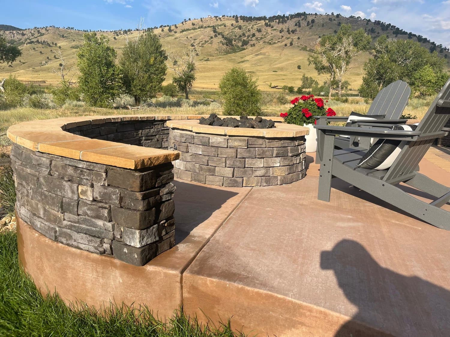 Firepit and seat wall with Colorado foothills backdrop by J&P Landscaping