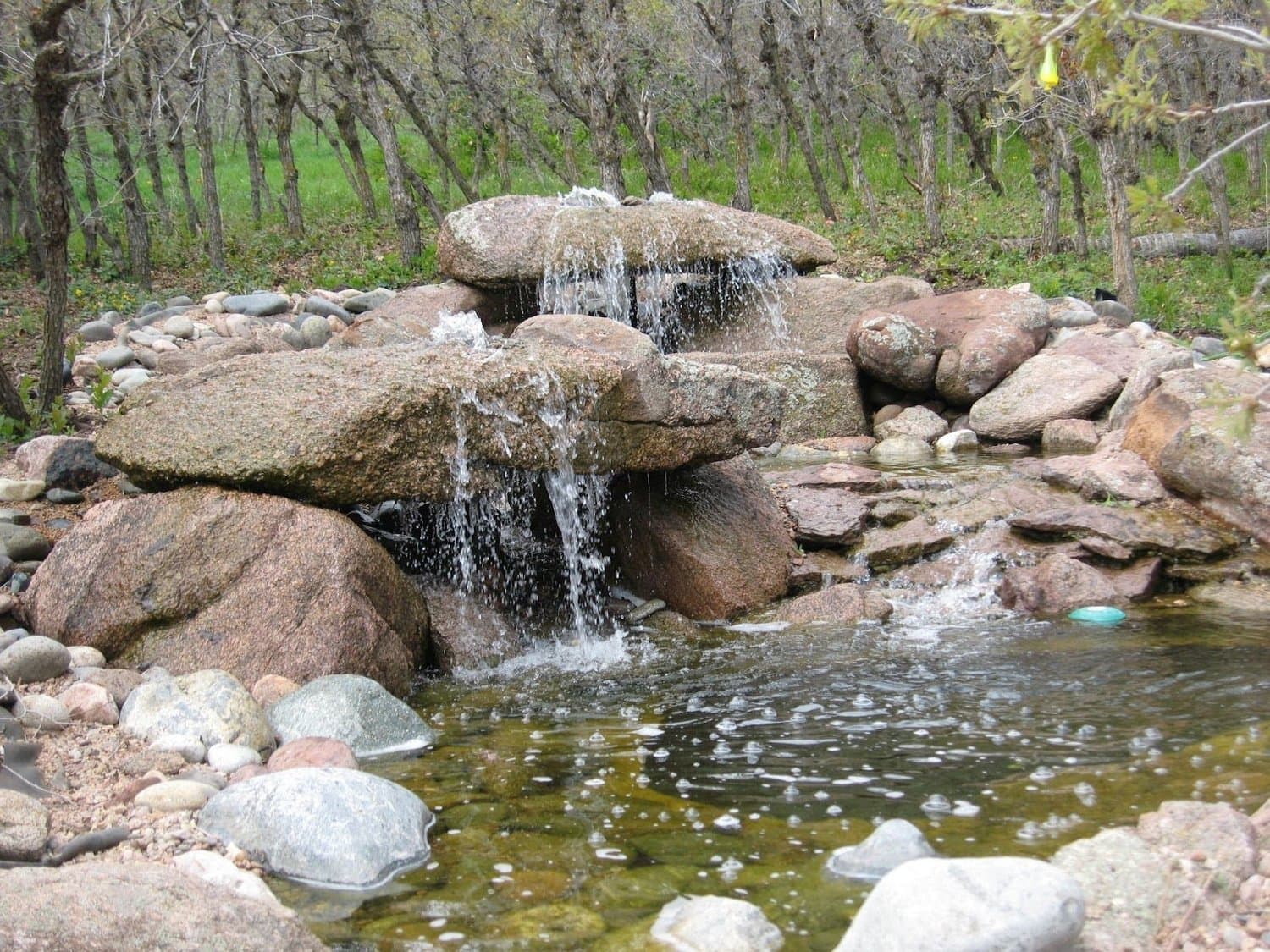 Natural stone waterfall water feature by J&P Landscaping